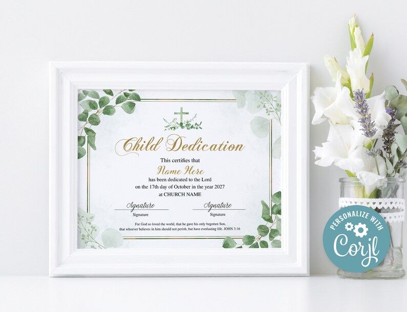 May include: A framed Child Dedication certificate with a white border. The certificate features gold script and a cross design, with green foliage accents. The text includes space for a name, date, and church name. A vase of white flowers is in the background.