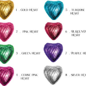 May include: Eight heart-shaped chocolates wrapped in foil, each a different color: gold, pink, green, cerise pink, turquoise, burgundy, purple, and silver. The chocolates are numbered 1 through 8.