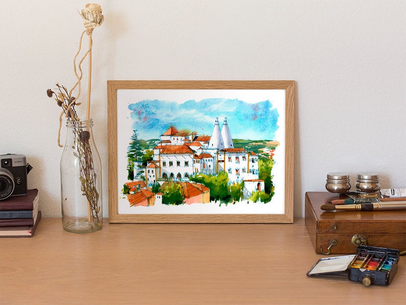 May include: Watercolor painting of a white building with red tile roofs and two tall white towers. The building is surrounded by trees and a blue sky with white clouds.