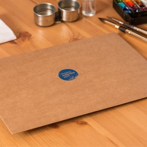 May include: A brown paper envelope with a blue circle sticker that says "drawingontheside.com" on it.