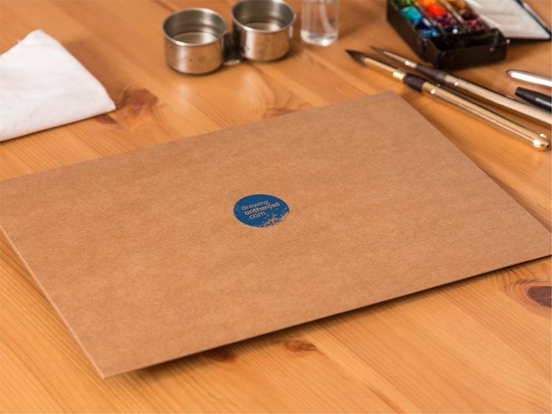 May include: A brown paper envelope with a blue circle sticker that says "drawingontheside.com" on it.