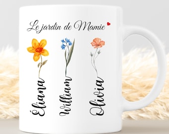 May include: White ceramic mug with the text "Le jardin de Mamie" and three watercolor flower illustrations. The names Eliana, William, and Olivia are written below each flower. A red heart is next to the text.