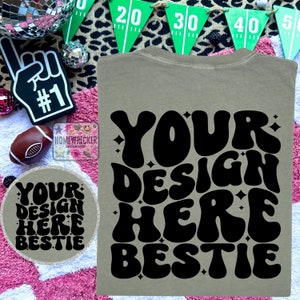 May include: A light brown t-shirt with a black graphic that says "YOUR DESIGN HERE BESTIE" in a retro, bubble-letter font.
