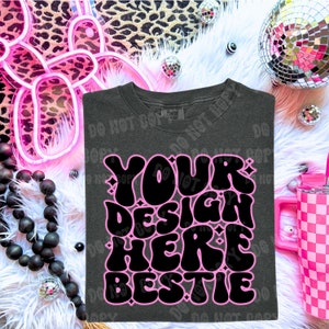 May include: A dark gray t-shirt with a pink and black graphic that says "YOUR DESIGN HERE BESTIE" in a retro font.