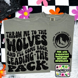 May include: A gray t-shirt with the text "Throw me to the wolves and I'll come back leading the pack" in black, with a wolf silhouette in a circle on the back. The text is in a retro font.