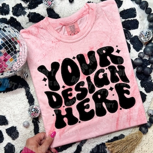 May include: Pink tie-dye t-shirt with the text "YOUR DESIGN HERE" in black retro font.