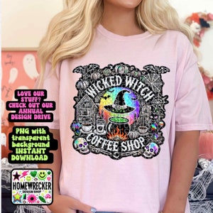 May include: A pink t-shirt with a black and white graphic design of a witch's cauldron, a coffee cup, and the text "Wicked Witch Coffee Shop". The graphic has a rainbow effect and includes skulls, bats, and pumpkins.