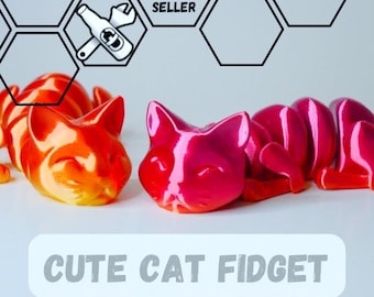 May include: A close-up of two cat-shaped fidget toys. One is orange and yellow, the other is pink and red. The text "CUTE CAT FIDGET" is at the bottom. The image also has an "OFFICIAL SELLER" logo.