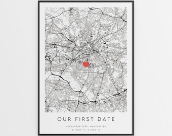 May include: Black and white map of Alexandra Park, Manchester, England with a red heart marking the location. The text "OUR FIRST DATE" is below the map, along with the coordinates "53.4505° N - 2.2500° W".