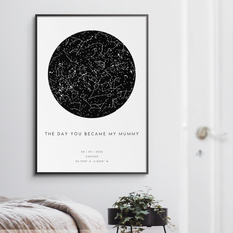 May include: Framed black and white print featuring a detailed star map within a circular design. The text "THE DAY YOU BECAME MY MUMMY" is displayed below the star map, along with a date, location, and coordinates.