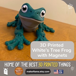 May include: 3D printed green tree frog with magnets. The frog has large eyes and is posed with its arms and legs outstretched. The text "3D Printed White's Tree Frog with Magnets" is displayed below the frog. The text "HOME OF THE BEST 3D PRINTED THINGS" is displayed below the text about the frog. The text "makerllama.etsy.com" is displayed below the text about the 3D printed things. The text "MADE IN USA" is displayed below the website address.
