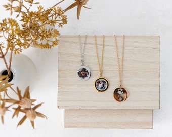May include: Three silver, gold, and rose gold necklaces with round pendants. The pendants feature a photo of a dog and a paw print.