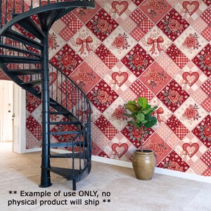 a spiral staircase with a red and white floral patterned wall behind it, and a potted plant in the foreground.