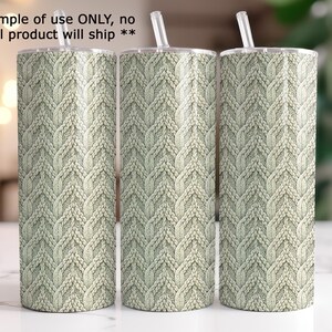 Three cylindrical objects with a knitted or woven pattern design on them, placed on a white surface.