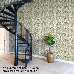 a spiral staircase with a knitted pattern on the wall behind it, and a potted plant in a brown vase is placed next to the staircase.