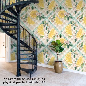 a spiral staircase with a vibrant lemon and orange patterned wall behind it, and a potted plant in the foreground.