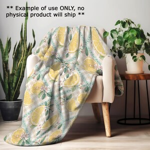 a cozy indoor setting with a chair, a potted plant, and a decorative throw blanket with a lemon and leaf pattern.