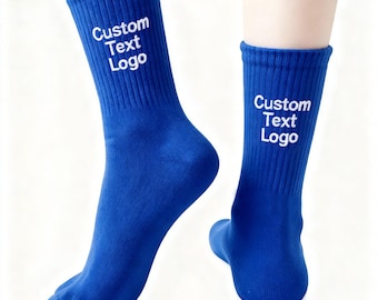 May include: A pair of royal blue socks with the text "Custom Text Logo" in white on the cuff. The socks are ribbed and appear to be made of a soft material. The socks are displayed on a white background.