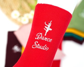 May include: Red cotton socks with a white embroidered ballerina and the text "Dance Studio".