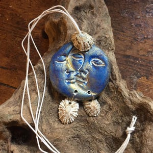 Large ceramic blue sun and moon face necklace with limpet shells, 6cm diameter