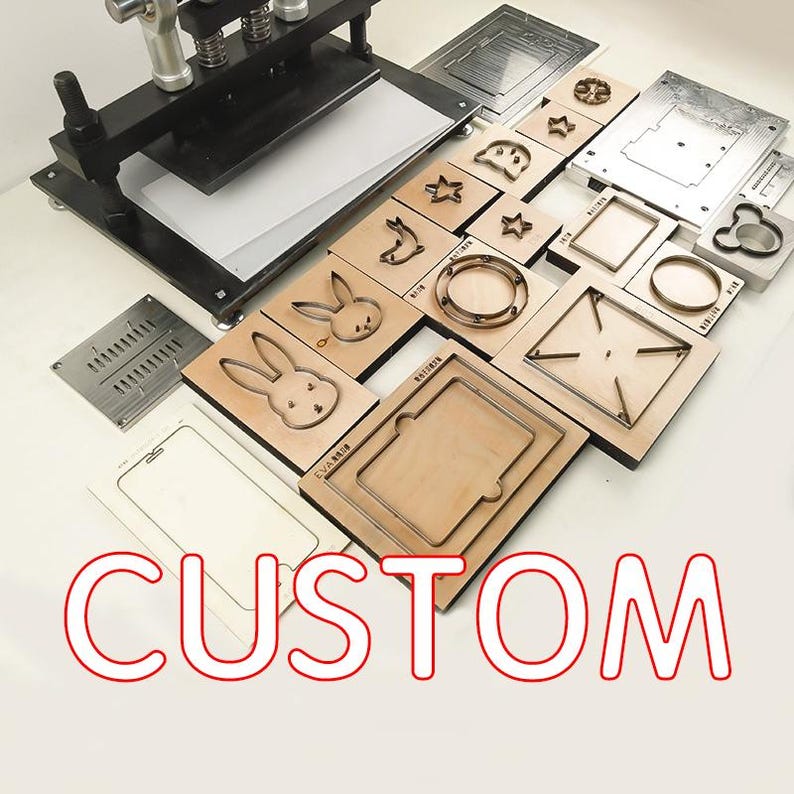 May include: A variety of metal and wood die cut shapes for crafting. The shapes include a star, a circle, a heart, a bunny, a rectangle, and a Mickey Mouse head. The die cuts are arranged on a wooden surface with the word "CUSTOM" printed in red letters.