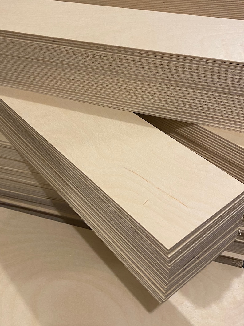 May include: A stack of light brown plywood boards. The boards are smooth and have a natural wood grain.