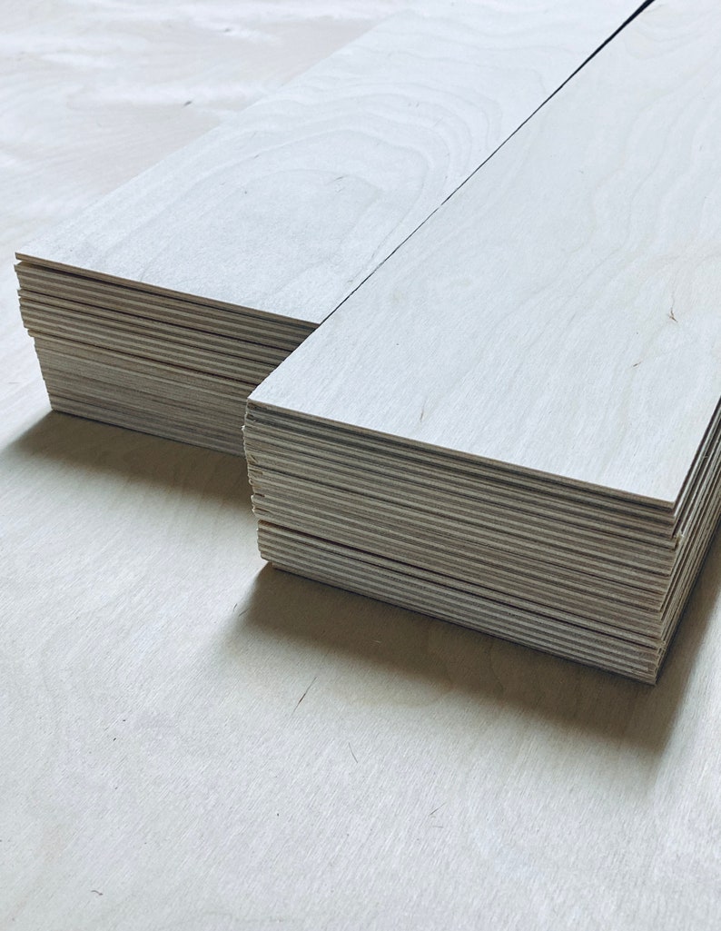 May include: A stack of light wood planks, likely for crafting or woodworking projects.