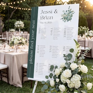 May include: A white wedding seating chart sign on a stand with a dark green side panel featuring the text please find your seat. The sign displays the names Jessi & Brian, the date May 16, 2025, and guest lists for tables one through eight.