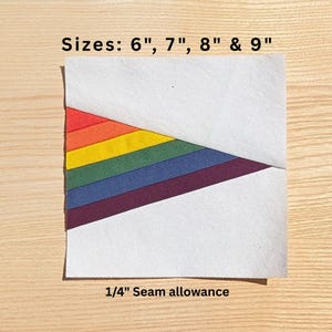 May include: A square fabric piece with a rainbow design, featuring red, orange, yellow, green, blue, and purple stripes. The text "Sizes: 6", 7", 8" & 9"" is at the top, and "1/4" Seam allowance" is at the bottom. The fabric is white with a diagonal rainbow pattern.