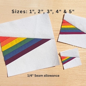 May include: Several white fabric pieces with a rainbow-colored stripe design. The sizes are 1", 2", 3", 4" & 5". The text "1/4" Seam allowance" is also visible.