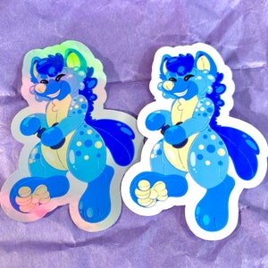 May include: Two blue and white holographic stickers of a cartoon animal with a happy expression. The animal is wearing a blue and white patterned outfit and has a blue tail.