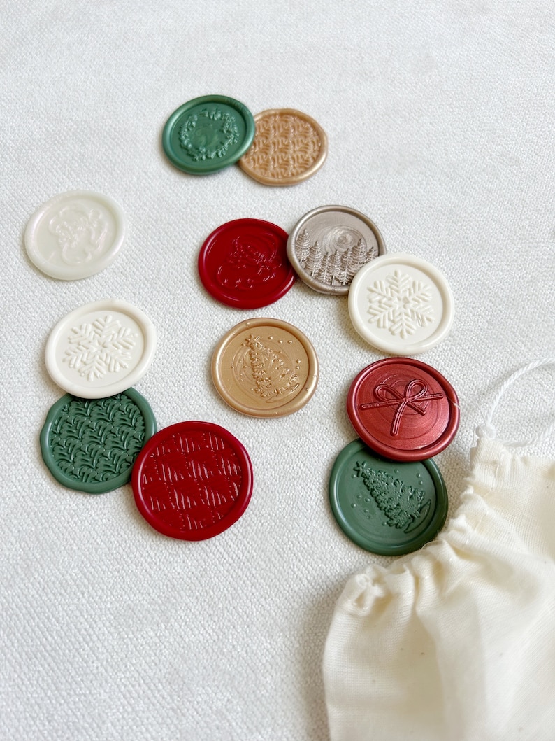 May include: Assortment of wax seals with various holiday designs, including snowflakes, Christmas trees, wreaths, and bows. The seals are in shades of red, green, gold, and white.