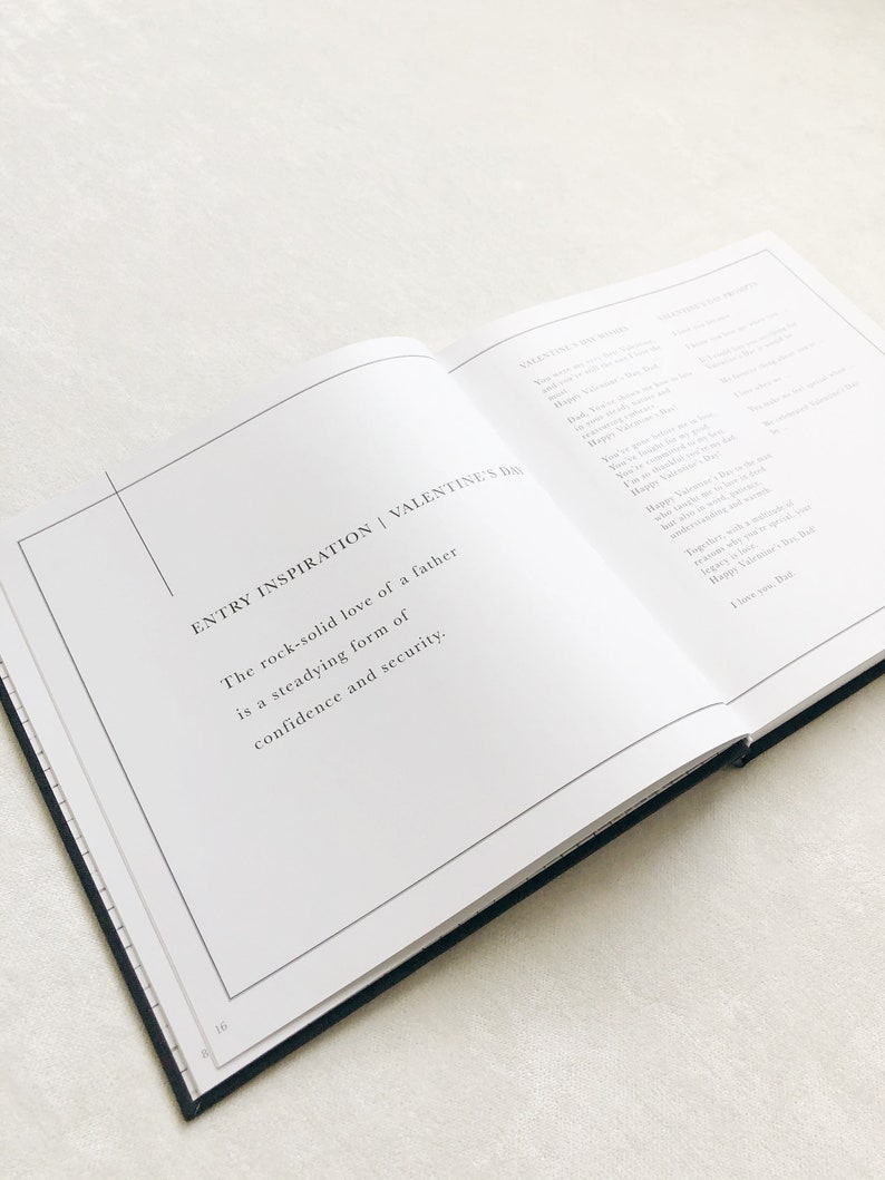 May include: An open book with a white background and black text. The text reads "ENTRY INSPIRATION | VALENTINE'S DAY" and "The rock-solid love of a father is a steadying form of confidence and security."