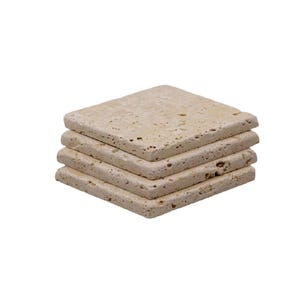 May include: A stack of four square coasters made of light beige stone. The coasters have a textured surface and rounded edges. They are stacked neatly on top of each other, showcasing their natural stone appearance.