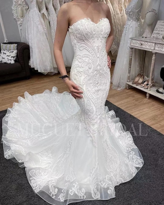 Shop spaghetti straps ivory lace bodice ruffled wedding dress from