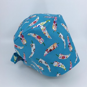 Fiesta Chili Peppers Scrub cap made from 100% preshrunk designer cotton fabric with back ties, adjustable brim, and enclosed elastic band.