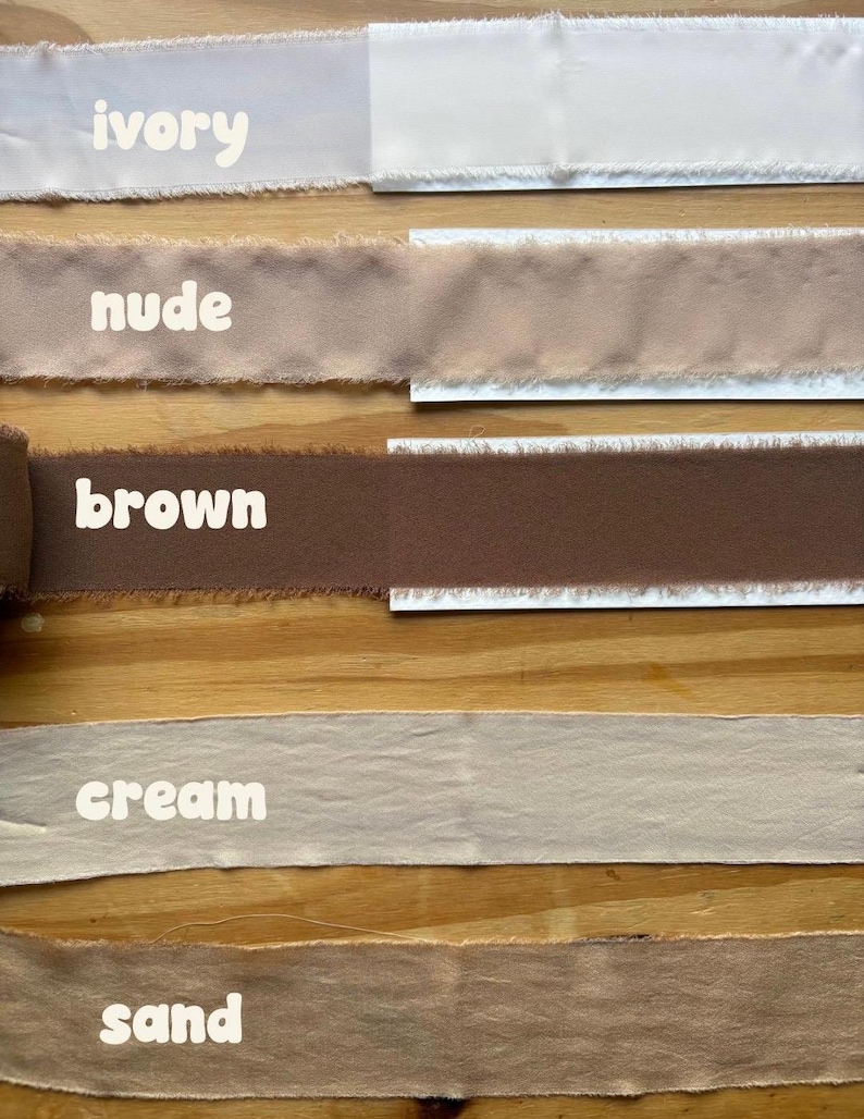 May include: A selection of fabric ribbons in various neutral colors, including ivory, nude, brown, cream, and sand. Each ribbon is labeled with its color name in white text. The ribbons have a frayed edge.