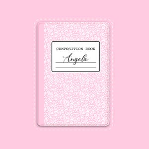 May include: A pink composition book with a white and pink speckled pattern. The cover features a label that reads "COMPOSITION BOOK" and the name "Angela" in cursive.