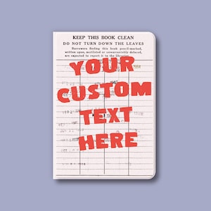 May include: A small, rectangular notebook with a vintage library card design. The cover features the text "KEEP THIS BOOK CLEAN" and "YOUR CUSTOM TEXT HERE" in red. The notebook has a light purple background.