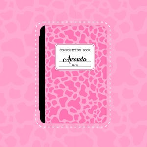 May include: A pink composition book with a cow print design. The cover features the name "Amanda" in cursive, with the text "COMPOSITION BOOK" above it and the date "11.01" below. The book has a black spine and a white dotted border.