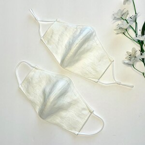 The face masks are available in two variants. One has adjustable elastic ear loops and one is fixed but flexible. The masks are made of 100% soft, breathable linen fabric.