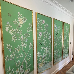 May include: Four framed wall art panels with a vivid green backdrop and gold frames. Each panel showcases a detailed floral and bird design in white, pink, and blue. The artwork brings a touch of nature-inspired elegance to any interior.