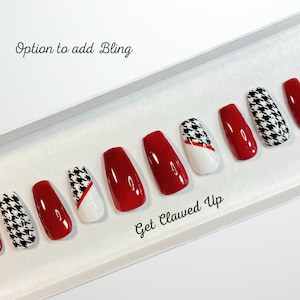 May include: Set of ten red and white press-on nails with a houndstooth pattern. The nails are in a white box with the text "Get Clawed Up" and "Option to add Bling".