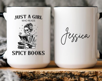 May include: White ceramic mug with a black handle and rim. The mug features the text "JUST A GIRL WHO READS SPICY BOOKS" with a skeleton illustration. The other side of the mug has the name "Jessica" in cursive.