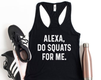 May include: Black tank top with white text that reads "Alexa, do squats for me."  The tank top is laying flat on a white surface with a pair of black and white sneakers and a rose gold water bottle.