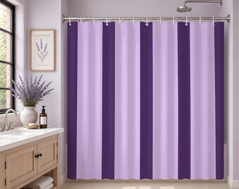 May include: A shower curtain featuring vertical stripes in alternating shades of deep purple and light lavender. The fabric hangs from a silver metal rod with circular rings, creating a pleated effect across the width of the curtain.