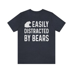 May include: A dark blue t-shirt with a white bear silhouette and the text "EASILY DISTRACTED BY BEARS".