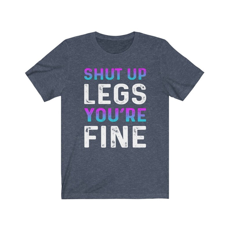 May include: A dark blue t-shirt with the text "SHUT UP LEGS YOU'RE FINE" in white with a gradient of pink and blue.