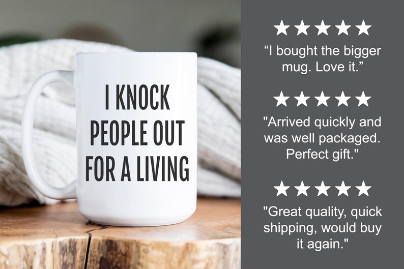 May include: White ceramic mug with the text "I KNOCK PEOPLE OUT FOR A LIVING" in black. The mug has a large handle and is displayed on a wooden surface. Customer reviews are visible in the background.