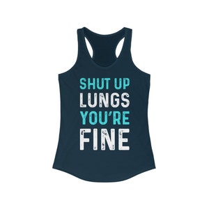 May include: A navy blue tank top with the text "SHUT UP LUNGS YOU'RE FINE" in white and turquoise lettering.
